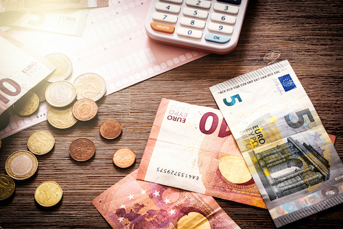 Euro,Banknotes,And,Coins,With,Bills,To,Pay.,Finances,And
